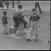 Boys playing on fountain. New York, NY