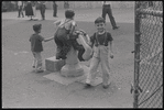 Boys playing on fountain. New York, NY