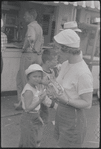Mother and daughter eating hot dogs [Provincetown, MA?]