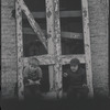 Children in the windows of an abandoned building