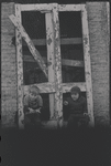 Children in the windows of an abandoned building
