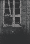 Children in the windows of an abandoned building