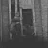 Children in the windows of an abandoned building