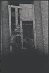 Children in the windows of an abandoned building