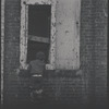 Children in the windows of an abandoned building