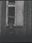 Children in the windows of an abandoned building