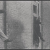 Children in the windows of an abandoned building