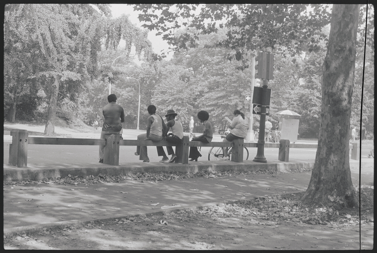 men sitting on fence in Central Park