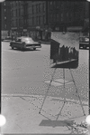 Artist painting on street corner. New York, NY