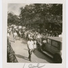 Scottsboro protest marchers raising their arms, in Harlem, New York