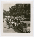 View of marchers following a sign depicting a Soviet worker standing on the top of the Earth, at  the Scottsboro protest parade, in Harlem, New York