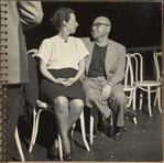 Robert Lewis and Agnes De Mille seated side by side looking at each other