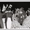 Group at night with paper bag hats surrounded by material as part of "Capture the Flag" happening at Jyväskylä, Finland