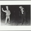 Two participants at night with paper bag hats as part of "Capture the Flag" happening at Jyväskylä, Finland