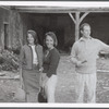 Group (3) outside dilapidated house during performance of The Gift