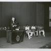 Cuban anthropologist Fernando Ortiz lecturing on Afro-Cuban music, assisted by three Black Cuban drummers playing batá drums, before a White audience in Havana, Cuba, on May 30, 1937