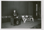 Cuban anthropologist Fernando Ortiz lecturing on Afro-Cuban music, assisted by three Black Cuban drummers playing batá drums, before a White audience in Havana, Cuba, on May 30, 1937