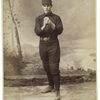 Unidentified baseball player in dark uniform - pitching form