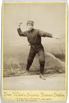 Unidentified baseball player in dark uniform - throwing form