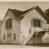 Exterior of the White Barn Theatre with Lucille Lortel on steps, ca. 1940s