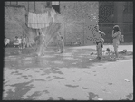 Children playing in a sprinkler