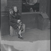 Elderly woman sitting on a crate