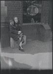 Elderly woman sitting on a crate