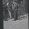 Young men outside a tailor shop