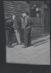 Young men outside a tailor shop