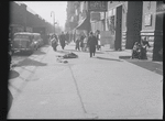 Man asleep on sidewalk