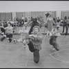 Unidentified man in rehearsal (chorus behind, all squatting leg kicks) for the stage production Woman of the Year