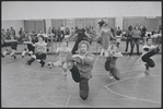 Unidentified man in rehearsal (chorus behind, all squatting leg kicks) for the stage production Woman of the Year