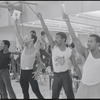Performers (arms raised) in rehearsal for the stage production Dreamgirls