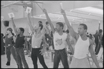 Performers (arms raised) in rehearsal for the stage production Dreamgirls