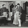 Two men and a woman, standing
