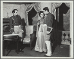 Two men and a woman, standing