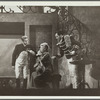 Woman sitting and two men standing