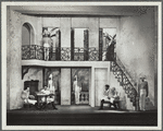Three men sitting, others on guard