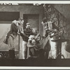 Woman smiling, surrounded by three men