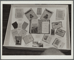 Display case at Harlem Art Center with patrons