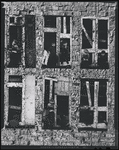 Children in the windows of an abandoned building