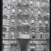 Fire escapes and flags. New York, NY