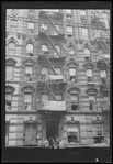 Fire escapes and flags. New York, NY