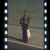 Woman in sunglasses standing on sidewalk