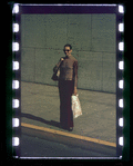 Woman in sunglasses standing on sidewalk