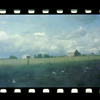 Field behind fence with two houses