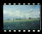 Field behind fence with two houses