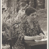 Seated portrait at desk in garden