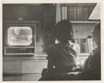  Unidentified man and child watching Arturo Toscanini conduct on television