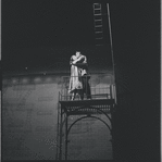 Carol Lawrence and Larry Kert on a fire escape in scene from the stage production West Side Story